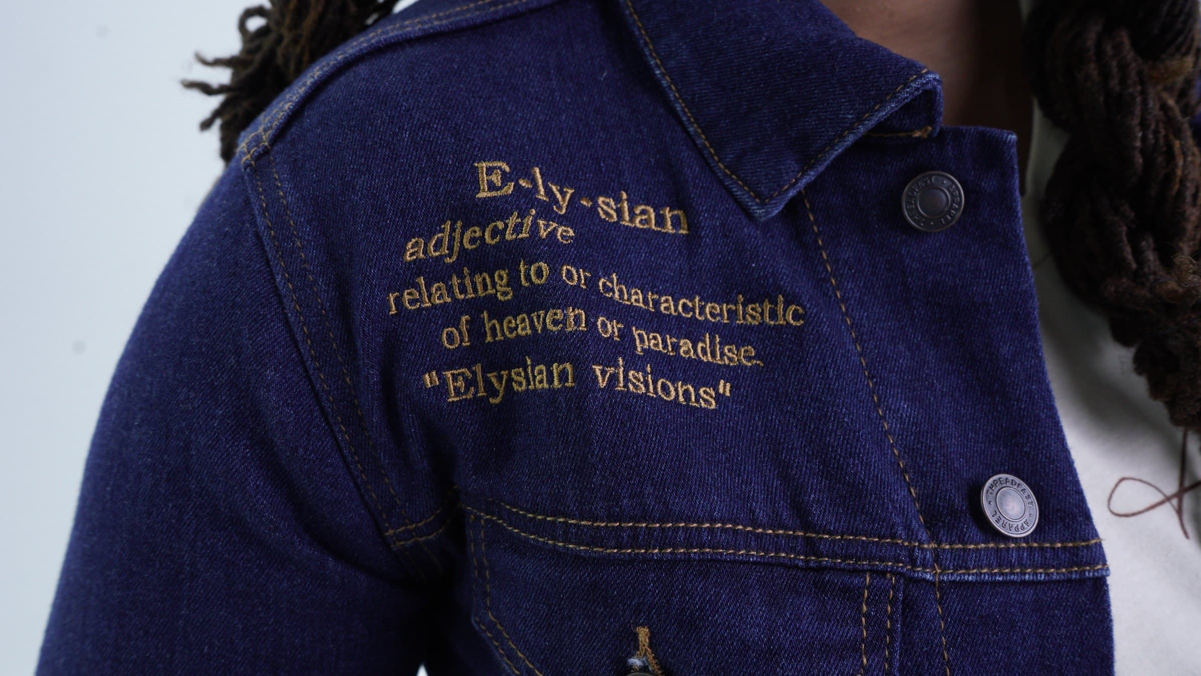 Embroidered Elysian lettering, close detail